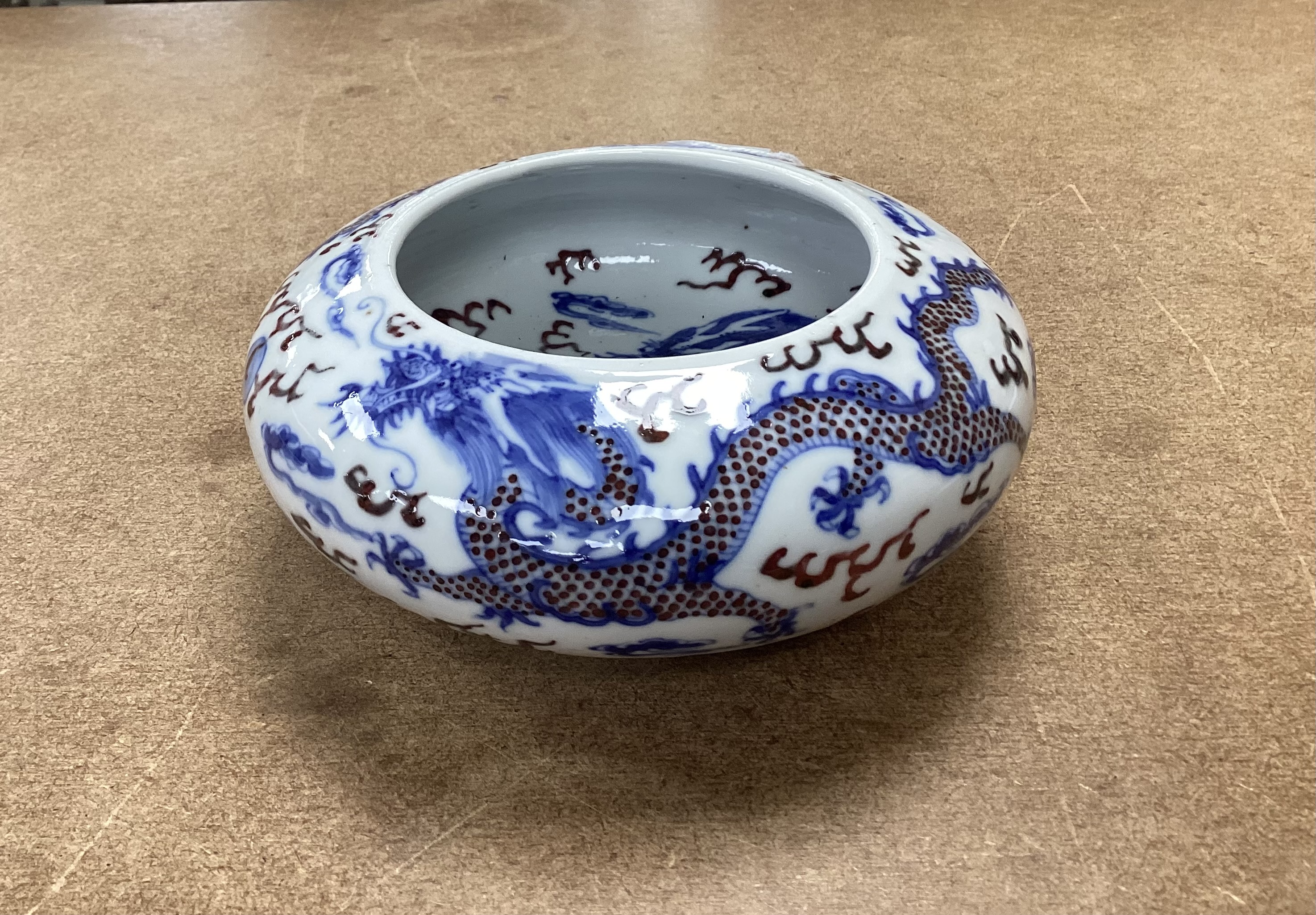 A Chinese underglaze blue and copper red ‘Dragon’ brushwasher, Guangxu period, 15cm diameter